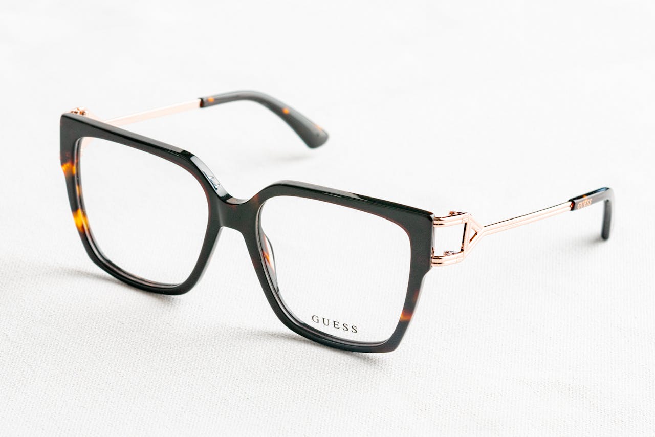 services-img-02 Close-up of fashionable Guess eyeglasses with tortoiseshell frame on white background.